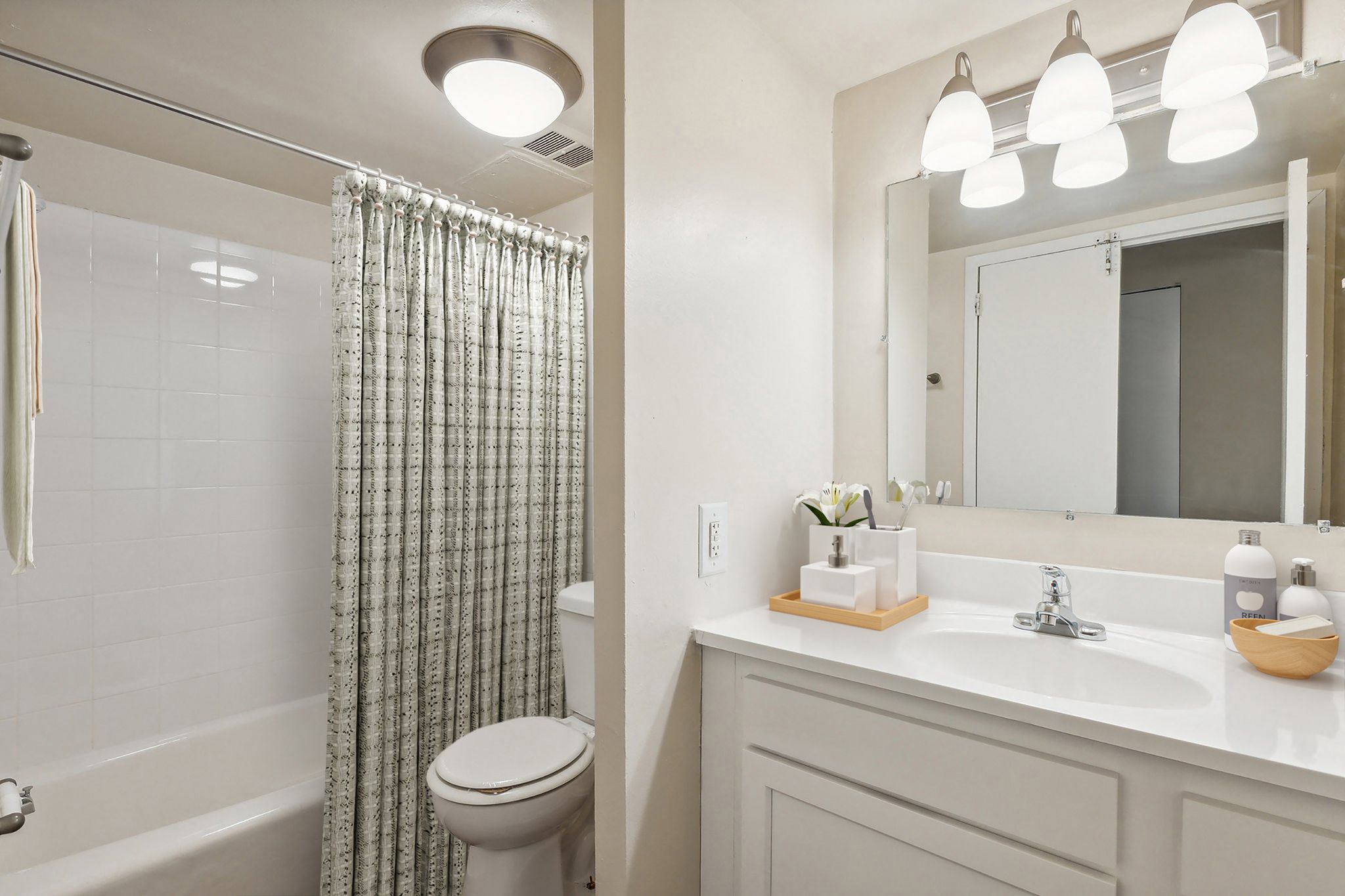 a bathroom with a shower and a sink and a toilet
